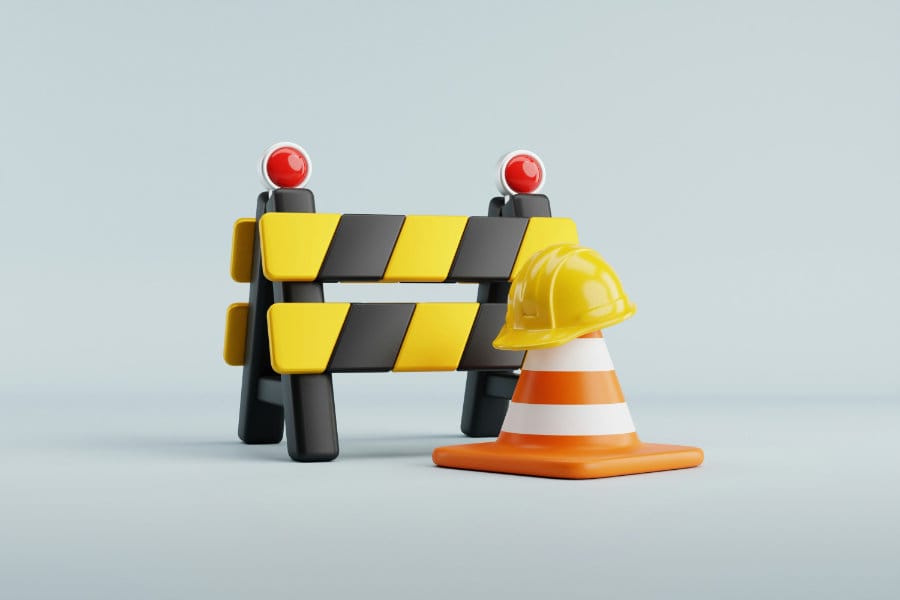 Image of construction items including a hard hat and traffic cone showing the web maintenance FAQs available on this page.