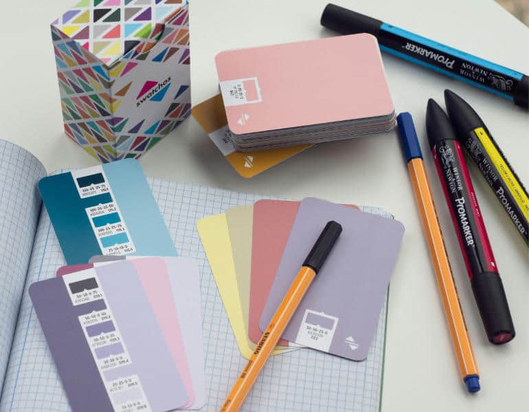 Assorted notebooks, pens, and markers for design and note-taking.